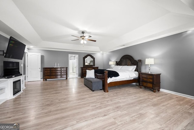143 Monarch Way, Hiram, GA 30141 - bedroom featuring a raised ceiling, light wood-style flooring, baseboards, and ceiling fan