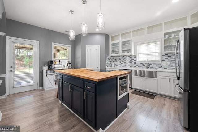 143 Monarch Way, Hiram, GA 30141 - kitchen featuring stainless steel appliances, wood counters, white cabinets, a sink, and backsplash