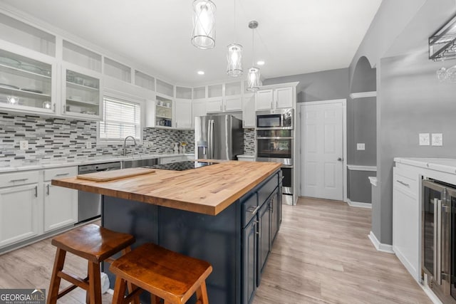 143 Monarch Way, Hiram, GA 30141 - kitchen with butcher block countertops, stainless steel appliances, white cabinets, wine cooler, and recessed lighting