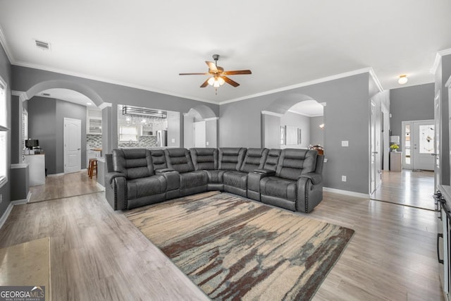 143 Monarch Way, Hiram, GA 30141 - living area with a ceiling fan, light wood-style flooring, arched walkways, baseboards, and crown molding