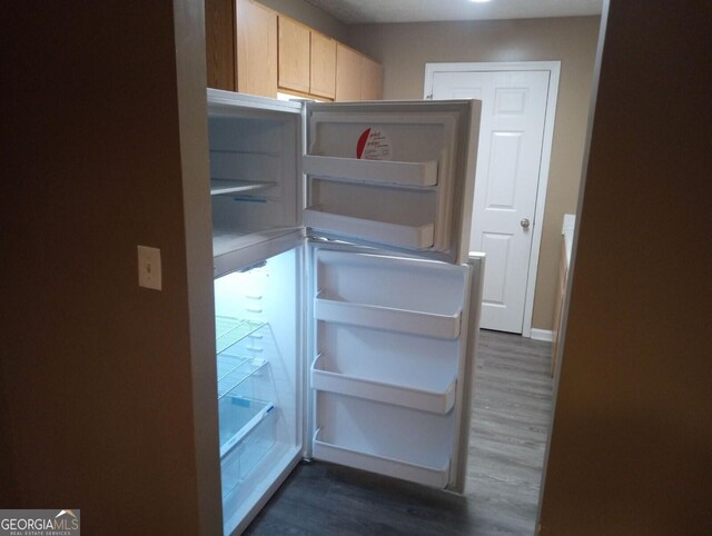 8202 Fairington Village Dr, Lithonia, GA 30038 - detailed view of wood finished floors, fridge, and light brown cabinets