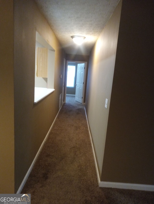 8202 Fairington Village Dr, Lithonia, GA 30038 - hallway featuring carpet, baseboards, and a textured ceiling