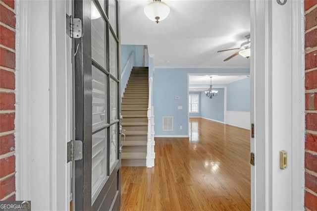 6206 Carriage Gate Ln Unit 6, Mableton, GA 30126 - hallway featuring stairs, wood finished floors, a chandelier, and ornamental molding