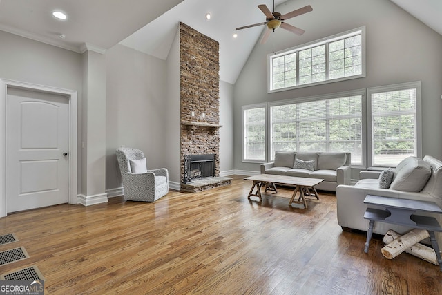 210 Short Rd, Sharpsburg, GA 30277 - living room featuring high vaulted ceiling, ceiling fan, a stone fireplace, wood finished floors, and baseboards