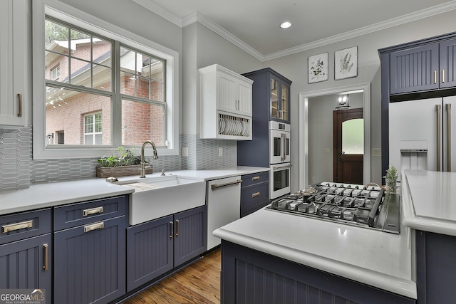 210 Short Rd, Sharpsburg, GA 30277 - kitchen with a sink, white appliances, blue cabinetry, tasteful backsplash, and ornamental molding