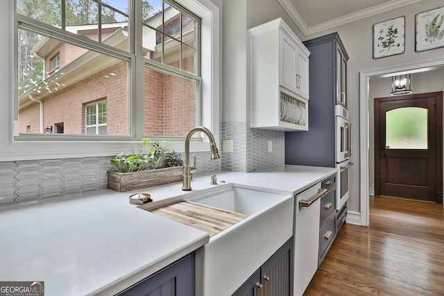 210 Short Rd, Sharpsburg, GA 30277 - kitchen featuring light countertops, a sink, backsplash, dishwasher, and crown molding