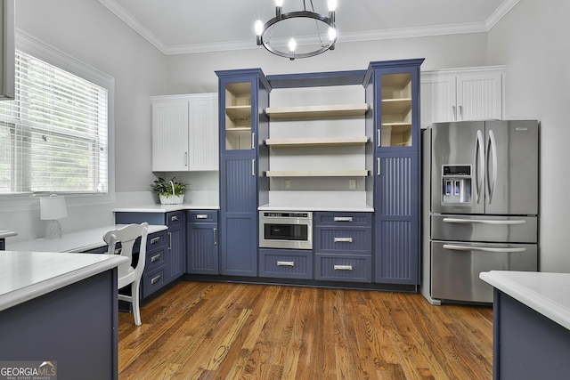 210 Short Rd, Sharpsburg, GA 30277 - kitchen with stainless steel appliances, light countertops, blue cabinetry, a chandelier, and crown molding