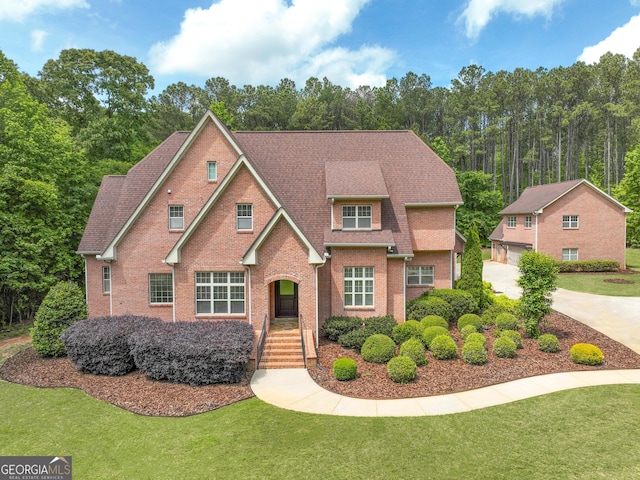 210 Short Rd, Sharpsburg, GA 30277 - view of front facade with a front yard, brick siding, a detached garage, and a shingled roof