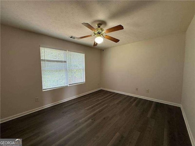 1720 New Orleans Way, Mcdonough, GA 30252 - empty room featuring dark wood-style floors, a textured ceiling, ceiling fan, and baseboards