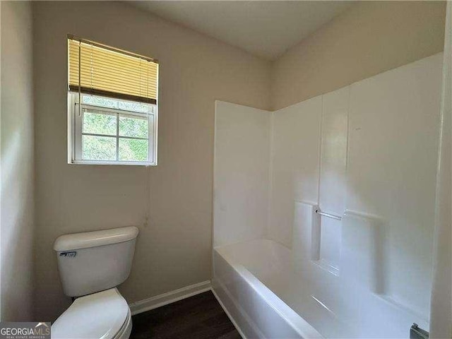 1720 New Orleans Way, Mcdonough, GA 30252 - full bath featuring toilet, baseboards, and wood finished floors
