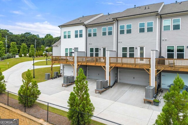 1172 Edwin Ln, Sugar Hill, GA 30518 - back of property featuring concrete driveway, an attached garage, and a yard