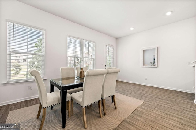 1172 Edwin Ln, Sugar Hill, GA 30518 - dining area with healthy amount of natural light, wood finished floors, and recessed lighting