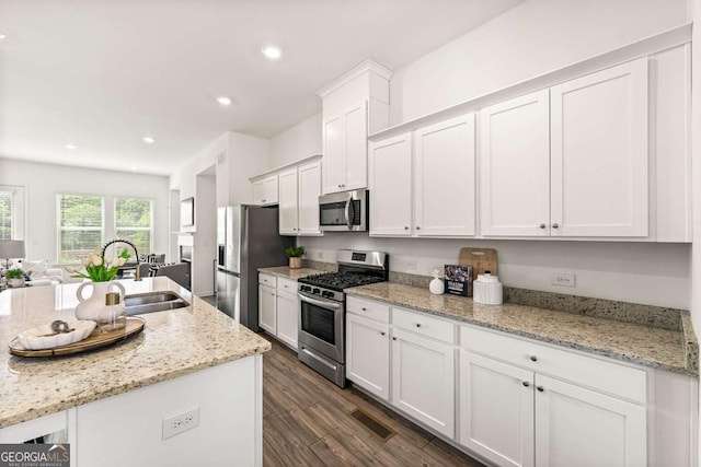 1172 Edwin Ln, Sugar Hill, GA 30518 - kitchen with stainless steel appliances, white cabinets, dark wood-type flooring, light stone counters, and recessed lighting