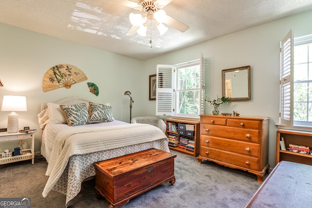 1750 Clairmont Rd Unit 35, Decatur, GA 30033 - carpeted bedroom featuring multiple windows, a textured ceiling, and a ceiling fan