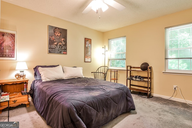 1750 Clairmont Rd Unit 35, Decatur, GA 30033 - carpeted bedroom with multiple windows, a textured ceiling, ceiling fan, and baseboards