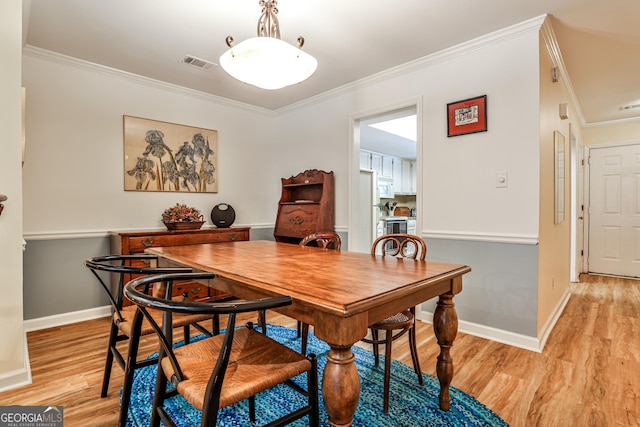 1750 Clairmont Rd Unit 35, Decatur, GA 30033 - dining space with crown molding, light wood-type flooring, and baseboards