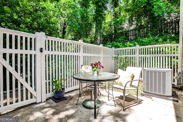 1750 Clairmont Rd Unit 35, Decatur, GA 30033 - view of patio featuring central AC unit and outdoor dining space