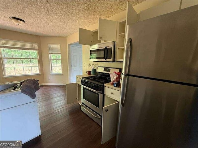 160 Goldleaf Dr, Hampton, GA 30228 - kitchen featuring stainless steel appliances, a textured ceiling, dark wood finished floors, light countertops, and baseboards