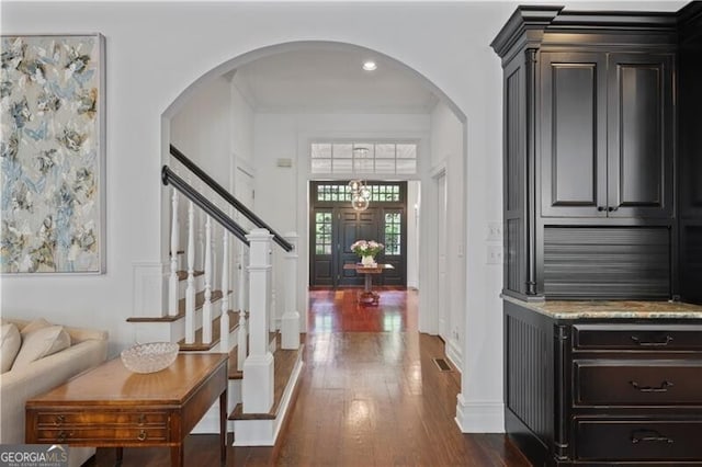 4356 N Buckhead Dr NE, Atlanta, GA 30342 - entrance foyer with dark wood-style flooring, arched walkways, and stairs