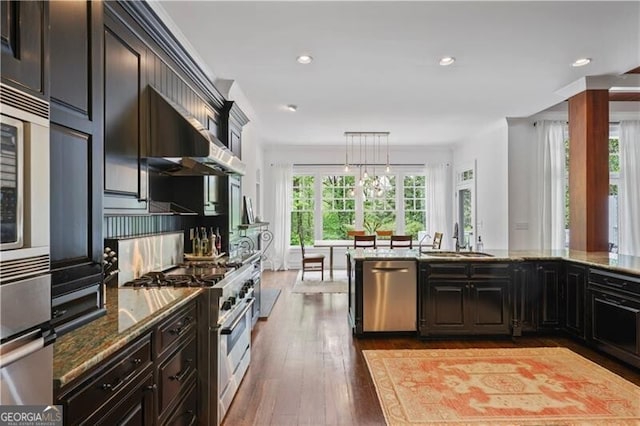 4356 N Buckhead Dr NE, Atlanta, GA 30342 - kitchen with stainless steel appliances, hardwood / wood-style flooring, stone counters, recessed lighting, and pendant lighting