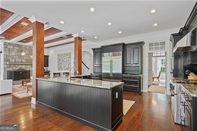 4356 N Buckhead Dr NE, Atlanta, GA 30342 - kitchen featuring high end appliances, light stone countertops, a peninsula, dark wood-style flooring, and recessed lighting