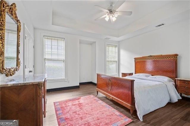 4356 N Buckhead Dr NE, Atlanta, GA 30342 - bedroom featuring wood finished floors, a raised ceiling, and ceiling fan