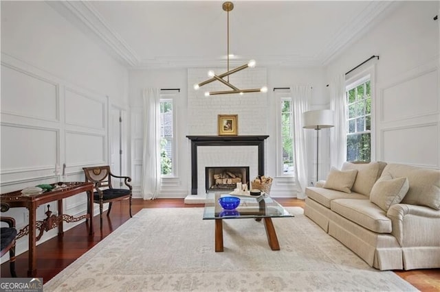 4356 N Buckhead Dr NE, Atlanta, GA 30342 - living room with a decorative wall, crown molding, wood finished floors, a brick fireplace, and a chandelier