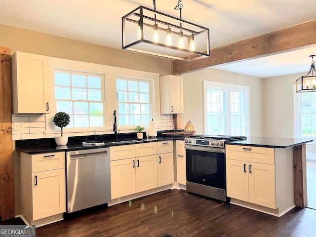 125 Oak Ave, Carrollton, GA 30117 - kitchen with stainless steel appliances, a peninsula, a sink, a chandelier, and backsplash