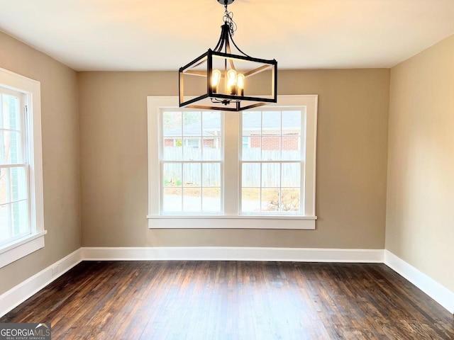 125 Oak Ave, Carrollton, GA 30117 - unfurnished dining area featuring a chandelier, healthy amount of natural light, and dark wood-type flooring