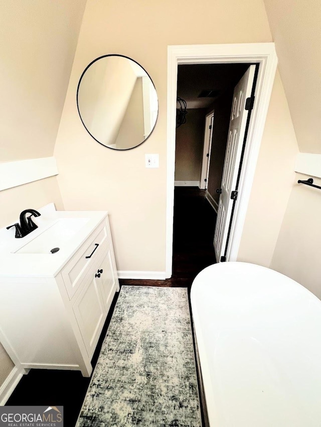 125 Oak Ave, Carrollton, GA 30117 - bathroom featuring vanity, wood finished floors, and baseboards