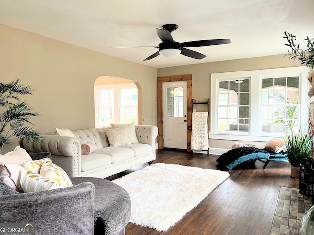 125 Oak Ave, Carrollton, GA 30117 - living room with arched walkways, dark wood-type flooring, a ceiling fan, and baseboards