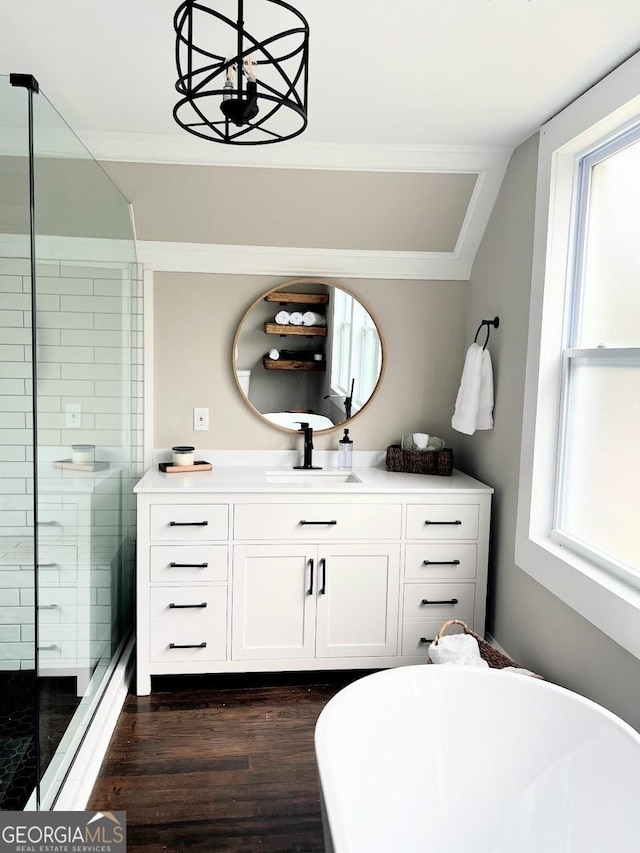 125 Oak Ave, Carrollton, GA 30117 - full bathroom with wood finished floors, vanity, plenty of natural light, a stall shower, and ornamental molding