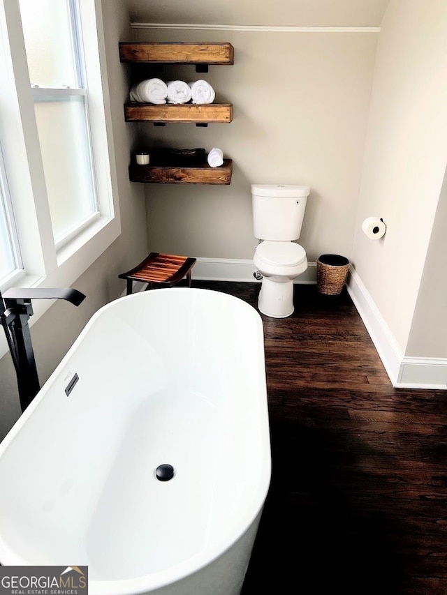 125 Oak Ave, Carrollton, GA 30117 - full bathroom featuring a freestanding bath, wood finished floors, baseboards, and crown molding