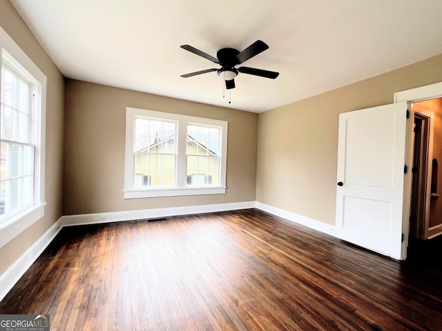 125 Oak Ave, Carrollton, GA 30117 - spare room with dark wood finished floors, baseboards, and a ceiling fan