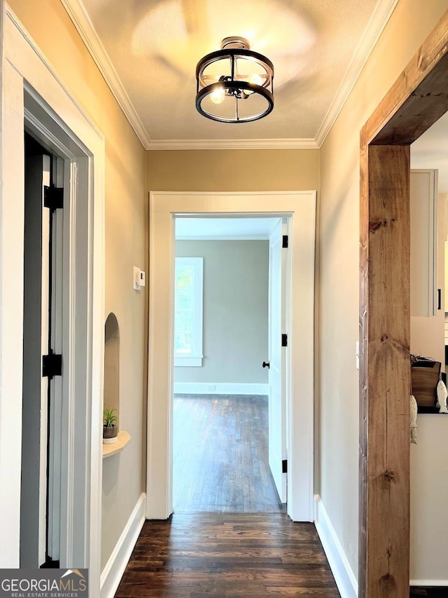 125 Oak Ave, Carrollton, GA 30117 - hall featuring dark wood finished floors, crown molding, baseboards, and a chandelier