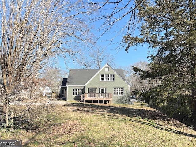125 Oak Ave, Carrollton, GA 30117 - rear view of property with a deck, a lawn, and stucco siding