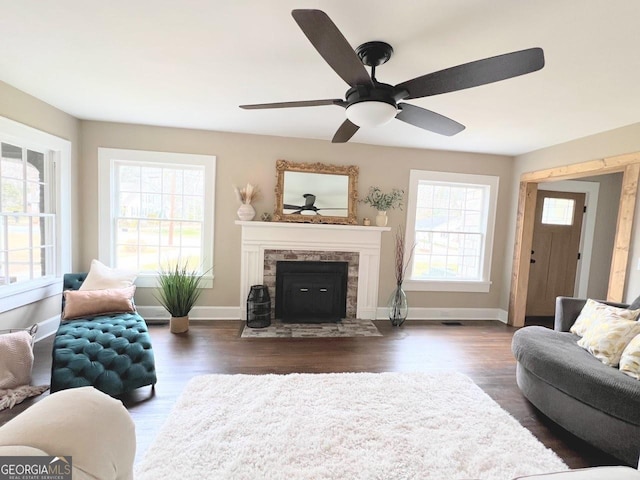 125 Oak Ave, Carrollton, GA 30117 - living room featuring a ceiling fan, dark wood-style floors, a tiled fireplace, and baseboards
