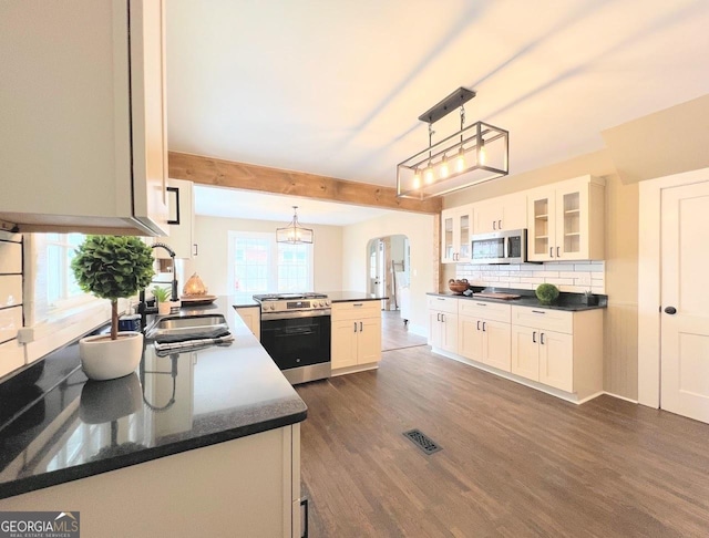 125 Oak Ave, Carrollton, GA 30117 - kitchen with stainless steel appliances, a sink, a peninsula, healthy amount of natural light, and beam ceiling