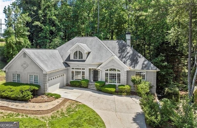3600 Goldenrod Dr, Alpharetta, GA 30005 - view of front of home with concrete driveway, an attached garage, and a chimney