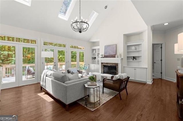 3600 Goldenrod Dr, Alpharetta, GA 30005 - living area featuring high vaulted ceiling, built in features, healthy amount of natural light, a fireplace, and a chandelier