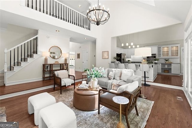 3600 Goldenrod Dr, Alpharetta, GA 30005 - living room with a high ceiling, dark wood-type flooring, stairway, a chandelier, and baseboards