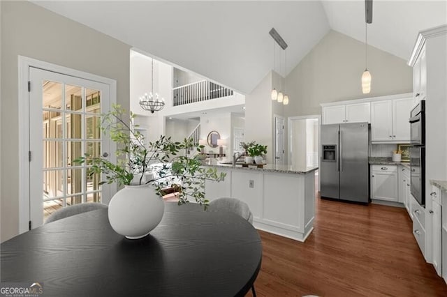 3600 Goldenrod Dr, Alpharetta, GA 30005 - dining space with high vaulted ceiling, dark wood-type flooring, a chandelier, and healthy amount of natural light