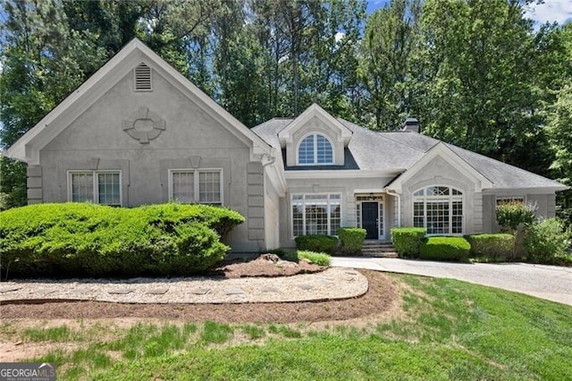 3600 Goldenrod Dr, Alpharetta, GA 30005 - view of front of home featuring a chimney, a front yard, and stone siding