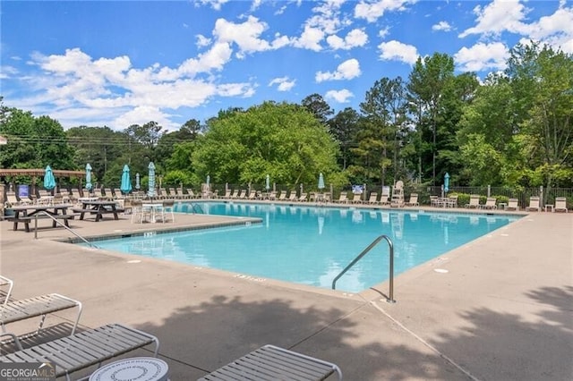 3600 Goldenrod Dr, Alpharetta, GA 30005 - community pool featuring a patio area and view of wooded area