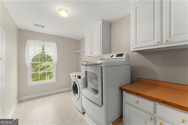 789 Rutland Ct, Lithonia, GA 30058 - laundry room with washer and clothes dryer, cabinet space, and baseboards