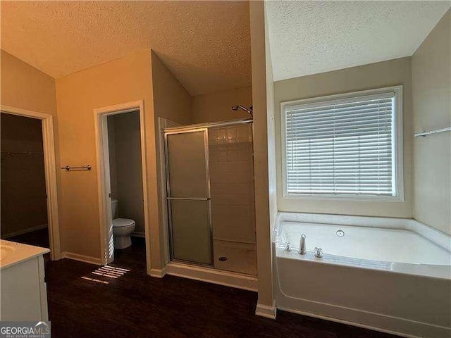 124 Sparkling Spring Trl, Mcdonough, GA 30252 - bathroom with a bath, a stall shower, toilet, a textured ceiling, and vanity