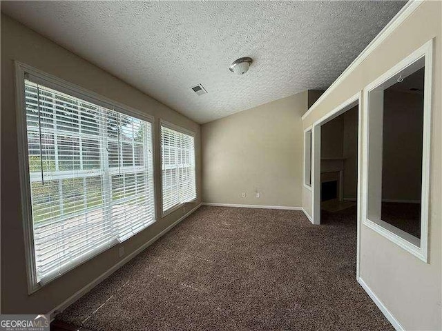 124 Sparkling Spring Trl, Mcdonough, GA 30252 - carpeted spare room featuring a textured ceiling, a fireplace, and baseboards