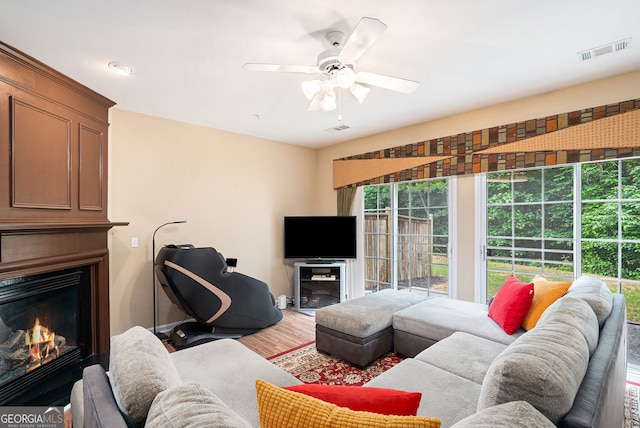129 Finsbury Ln, Woodstock, GA 30188 - living area with a fireplace, a ceiling fan, wood finished floors, and baseboards