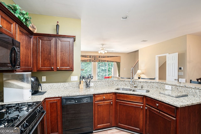 129 Finsbury Ln, Woodstock, GA 30188 - kitchen featuring black appliances, a sink, ceiling fan, light stone counters, and a peninsula