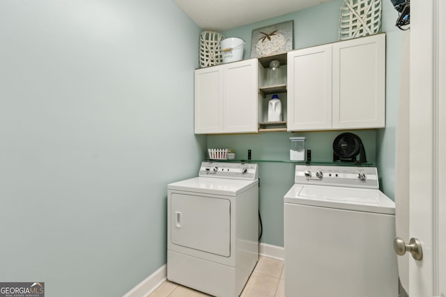 247 Laurel Landing Blvd, Kingsland, GA 31548 - laundry area with cabinet space, washing machine and dryer, light tile patterned flooring, and baseboards